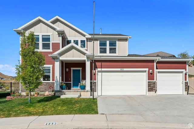 4852 N Arctic Fox Cir W Unit 2800, Lehi, UT 84043 - craftsman house featuring fence, a front lawn, stone siding, board and batten siding, and concrete driveway