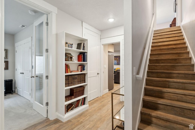 4852 N Arctic Fox Cir W Unit 2800, Lehi, UT 84043 - stairway featuring baseboards, visible vents, radiator heating unit, and wood finished floors