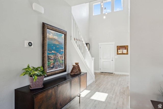 4852 N Arctic Fox Cir W Unit 2800, Lehi, UT 84043 - foyer featuring baseboards, light wood-style flooring, stairway, and a towering ceiling