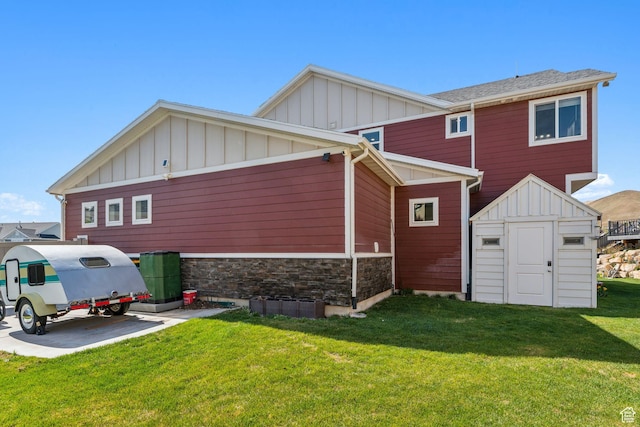 4852 N Arctic Fox Cir W Unit 2800, Lehi, UT 84043 - rear view of house with a storage unit, stone siding, board and batten siding, a lawn, and an outdoor structure