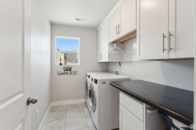 4852 N Arctic Fox Cir W Unit 2800, Lehi, UT 84043 - laundry room featuring visible vents, baseboards, washer and clothes dryer, cabinet space, and light tile patterned floors