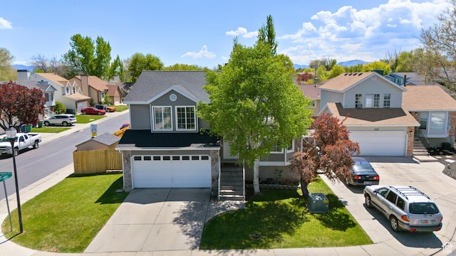 3429 W Beckford Cir, West Jordan, UT 84088 - view of front of house featuring an attached garage, driveway, a residential view, and a front lawn