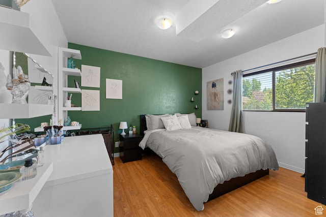 3429 W Beckford Cir, West Jordan, UT 84088 - bedroom with an accent wall and light wood-style flooring