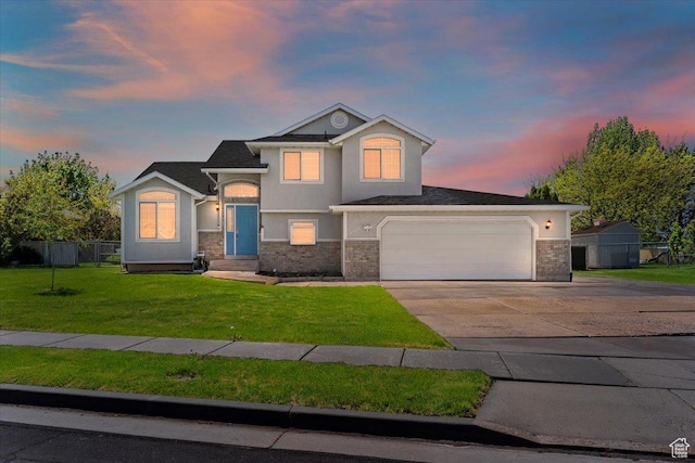 2437 W 2375 N, Clinton, UT 84015 - view of front of house featuring a front yard, a garage, fence, concrete driveway, and stucco siding