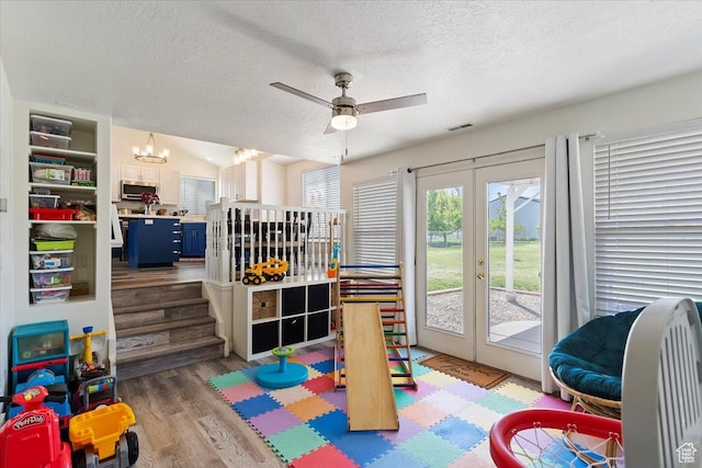 2437 W 2375 N, Clinton, UT 84015 - recreation room featuring a textured ceiling, visible vents, french doors, and wood finished floors
