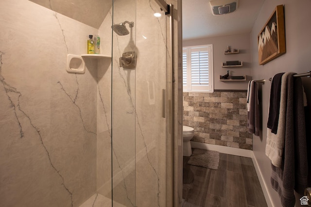 5716 S Maplewood Dr E, South Ogden, UT 84405 - bathroom featuring visible vents, wainscoting, wood finished floors, toilet, and a marble finish shower
