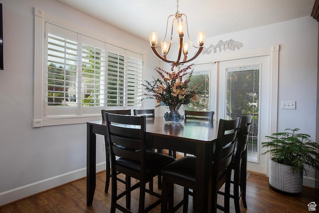 5716 S Maplewood Dr E, South Ogden, UT 84405 - dining area with baseboards, a chandelier, a wealth of natural light, and wood finished floors