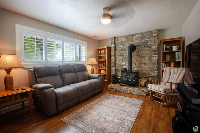 5716 S Maplewood Dr E, South Ogden, UT 84405 - living area featuring wood-type flooring, a wood stove, a textured ceiling, and ceiling fan