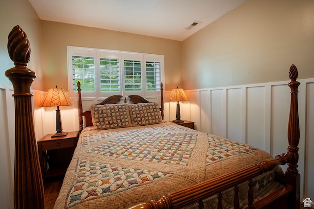 5716 S Maplewood Dr E, South Ogden, UT 84405 - bedroom featuring a wainscoted wall, a decorative wall, and visible vents