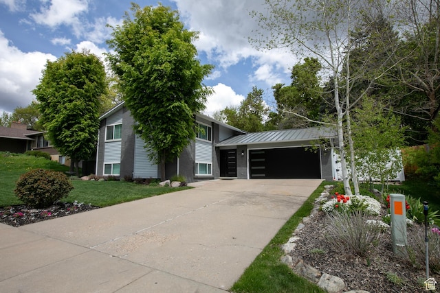 5716 S Maplewood Dr E, South Ogden, UT 84405 - view of front of home featuring a front yard, a standing seam roof, metal roof, an attached garage, and driveway