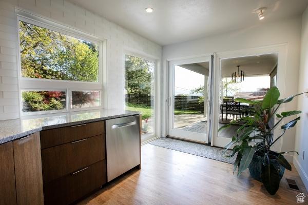 2812 E Commonwealth Ave S, Salt Lake City, UT 84109 - doorway to outside featuring visible vents, light wood-style flooring, and a notable chandelier