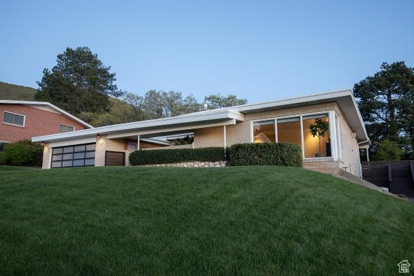 2812 E Commonwealth Ave S, Salt Lake City, UT 84109 - view of front of property with an attached garage and a front lawn