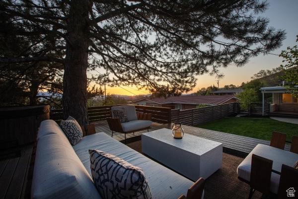 2812 E Commonwealth Ave S, Salt Lake City, UT 84109 - patio terrace at dusk featuring an outdoor living space, fence, and a deck