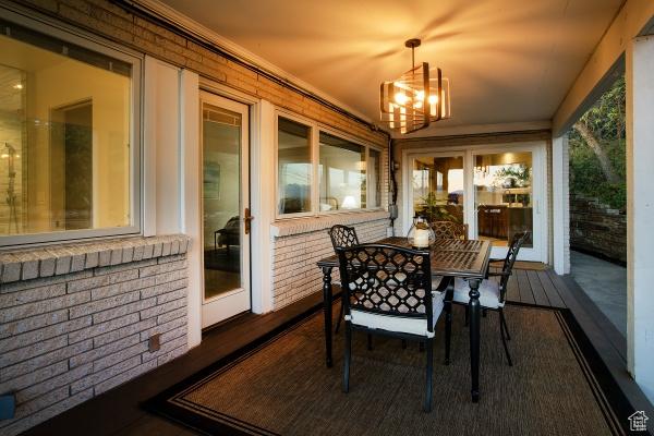 2812 E Commonwealth Ave S, Salt Lake City, UT 84109 - sunroom / solarium featuring brick wall and an inviting chandelier
