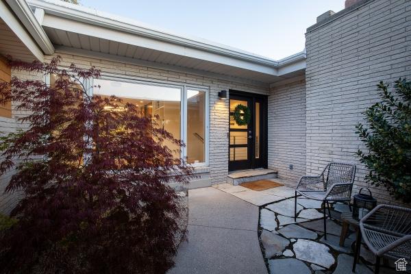 2812 E Commonwealth Ave S, Salt Lake City, UT 84109 - entrance to property with brick siding, a chimney, and a patio area