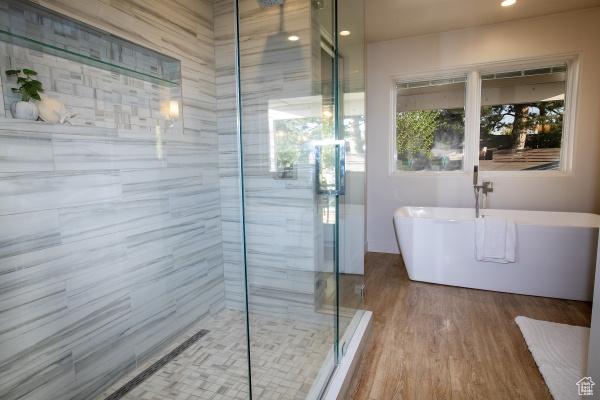 2812 E Commonwealth Ave S, Salt Lake City, UT 84109 - full bath featuring a soaking tub, a stall shower, recessed lighting, and wood finished floors