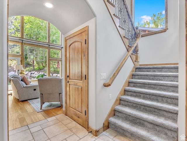 14099 S Pine Mesa Dr, Draper, UT 84020 - stairway featuring plenty of natural light, baseboards, tile patterned flooring, and vaulted ceiling
