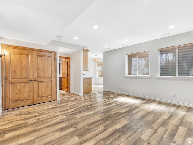 14099 S Pine Mesa Dr, Draper, UT 84020 - unfurnished living room featuring light wood-style floors, baseboards, recessed lighting, and visible vents