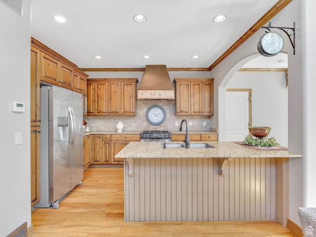 14099 S Pine Mesa Dr, Draper, UT 84020 - kitchen with crown molding, premium range hood, light stone counters, a sink, and stainless steel appliances
