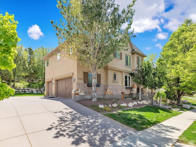 14099 S Pine Mesa Dr, Draper, UT 84020 - view of front facade featuring brick siding, a garage, stucco siding, a front yard, and concrete driveway