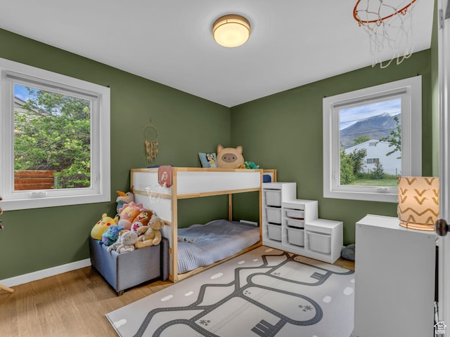 3133 S 2700 E, Millcreek, UT 84109 - bedroom featuring baseboards, multiple windows, and wood finished floors