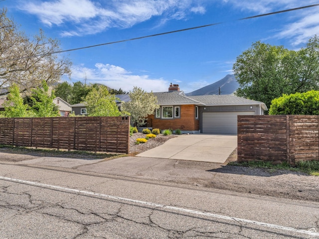 3133 S 2700 E, Millcreek, UT 84109 - ranch-style home with a garage, a chimney, concrete driveway, and fence private yard