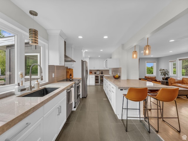 3133 S 2700 E, Millcreek, UT 84109 - kitchen featuring a sink, appliances with stainless steel finishes, backsplash, and white cabinets