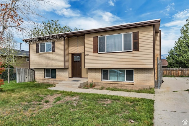 8729 S 3720 W, West Jordan, UT 84088 - raised ranch with brick siding, fence, and a front lawn