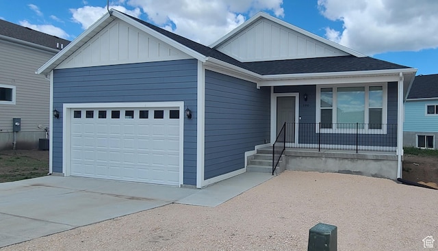 ranch-style home with an attached garage, board and batten siding, covered porch, and concrete driveway