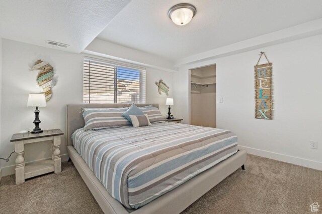 2242 S Beachcomber Ln, Garden City, UT 84028 - bedroom featuring carpet floors, visible vents, a closet, baseboards, and a walk in closet