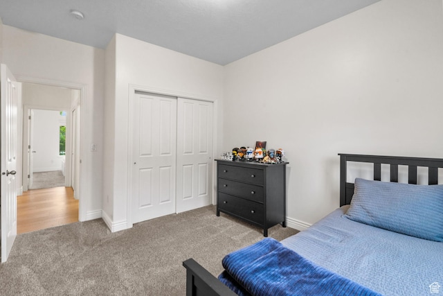 bedroom with a closet, carpet, and baseboards