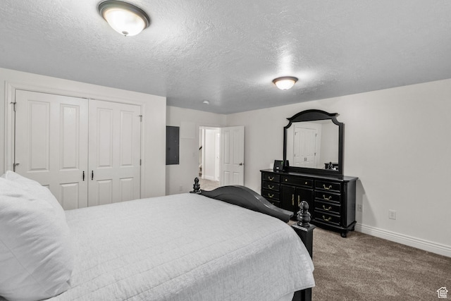 bedroom with electric panel, a textured ceiling, carpet, baseboards, and a closet