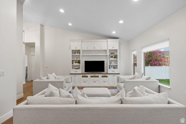living area featuring recessed lighting, baseboards, wood finished floors, and lofted ceiling