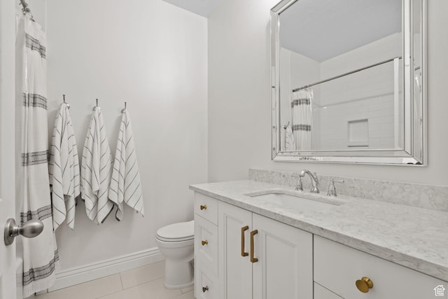 bathroom featuring vanity, tile patterned flooring, toilet, and curtained shower