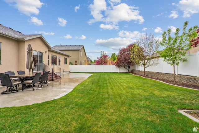view of yard with a fenced backyard and a patio area