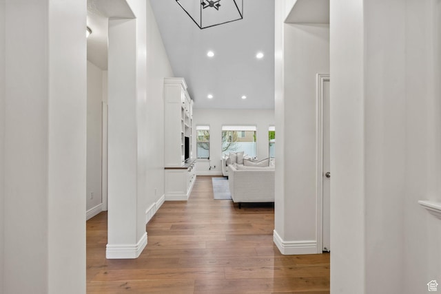 hallway with recessed lighting, baseboards, and light wood-type flooring
