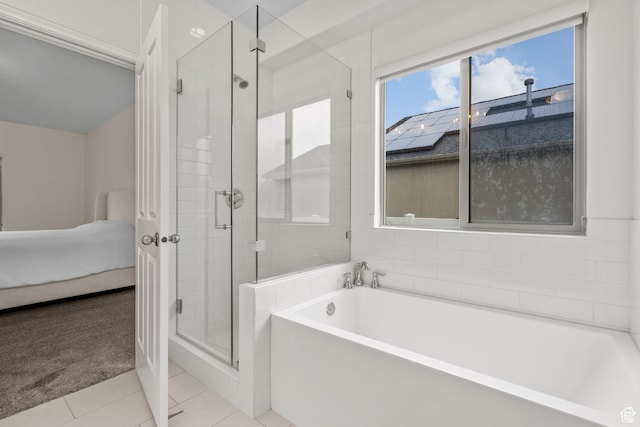 bathroom featuring ensuite bathroom, a garden tub, a stall shower, and tile patterned flooring