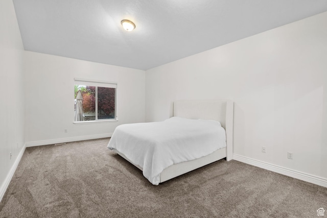 carpeted bedroom with baseboards