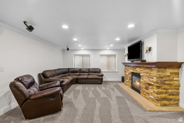 living room featuring ornamental molding, baseboards, a stone fireplace, recessed lighting, and light colored carpet