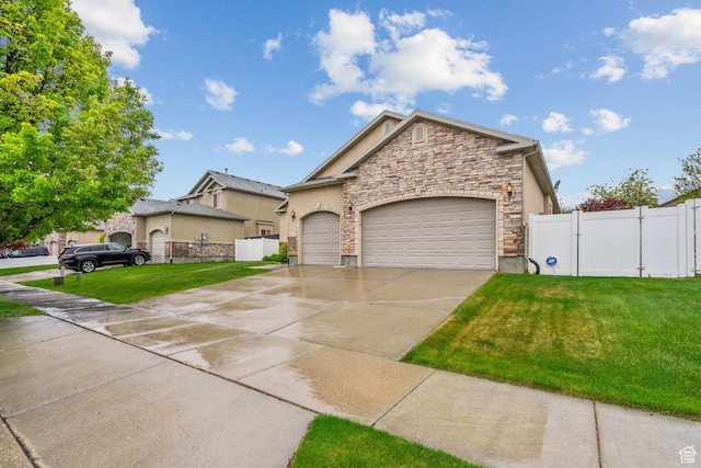 view of front facade featuring a garage, fence, a front lawn, concrete driveway, and stone siding