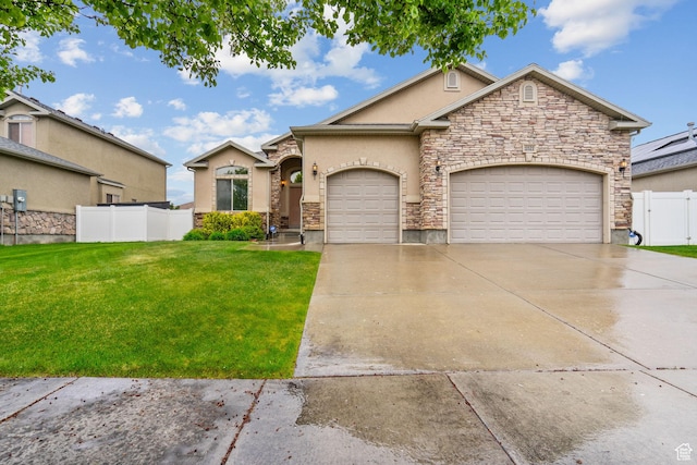 view of front facade featuring an attached garage, a front lawn, stone siding, stucco siding, and concrete driveway
