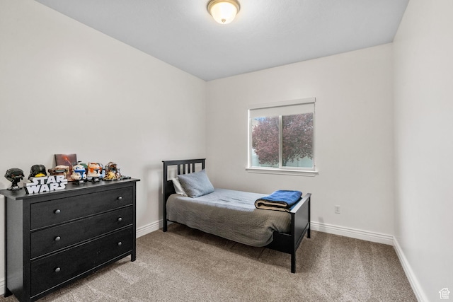 bedroom featuring baseboards and carpet flooring