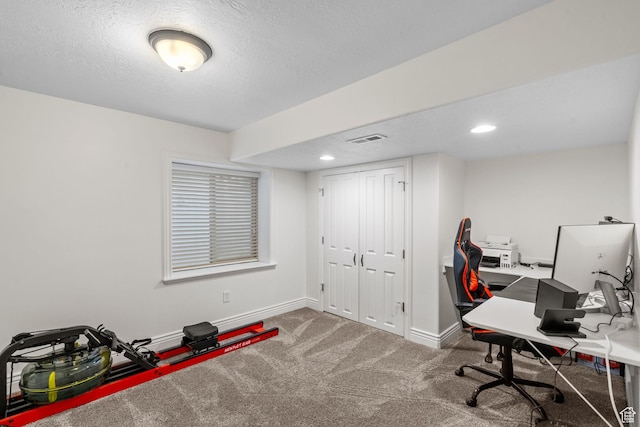 office area featuring carpet floors, a textured ceiling, recessed lighting, baseboards, and visible vents