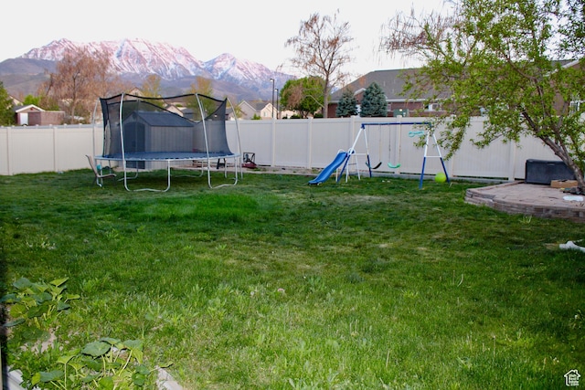 512 Stone Way, Santaquin, UT 84655 - view of yard featuring a fenced backyard, a playground, a trampoline, a mountain view, and a storage shed