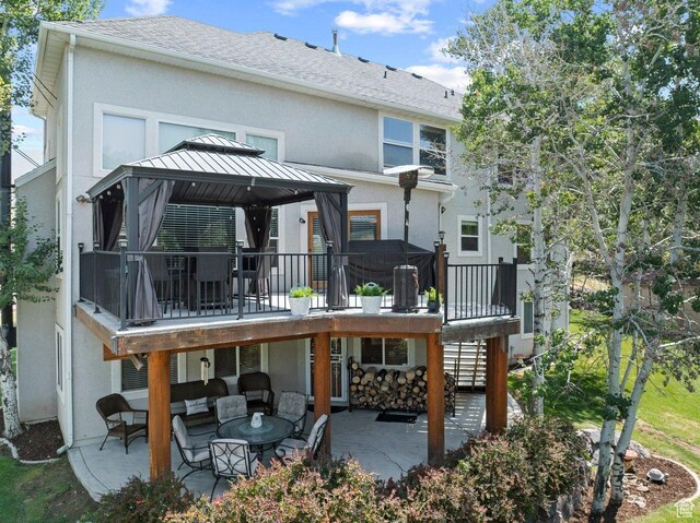 288 S Hillside Dr E, Elk Ridge, UT 84651 - rear view of house with a gazebo, stucco siding, an outdoor hangout area, and a patio