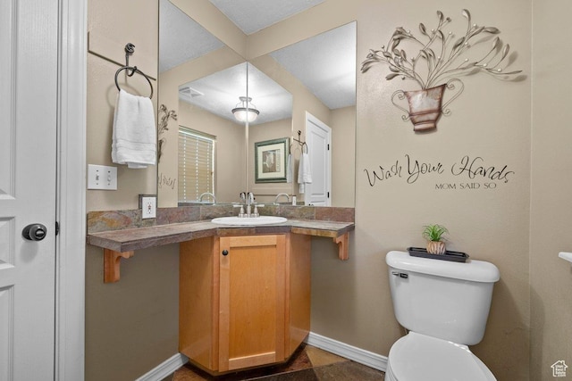 288 S Hillside Dr E, Elk Ridge, UT 84651 - half bathroom with baseboards, toilet, and vanity