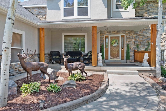 288 S Hillside Dr E, Elk Ridge, UT 84651 - property entrance with a porch, stone siding, and stucco siding