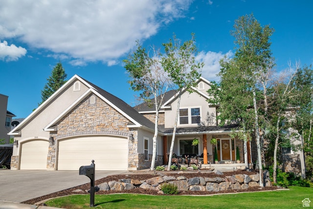 288 S Hillside Dr E, Elk Ridge, UT 84651 - craftsman house with stone siding, stucco siding, covered porch, and a garage