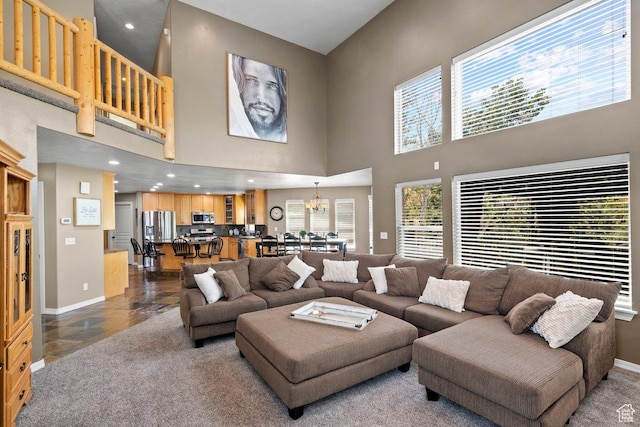 288 S Hillside Dr E, Elk Ridge, UT 84651 - living area featuring baseboards, a notable chandelier, and a towering ceiling