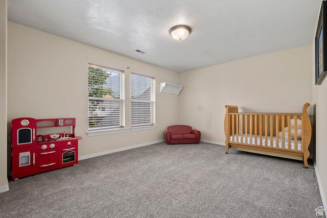 288 S Hillside Dr E, Elk Ridge, UT 84651 - bedroom with visible vents, baseboards, a textured ceiling, a nursery area, and carpet flooring